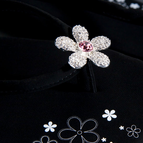 Close up of jewelry Black Designer Flip Flops Pave Flower
