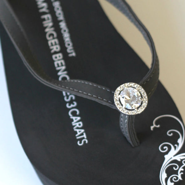 Closeup of Vintage Diamond Ring jewelry on gray flip flops