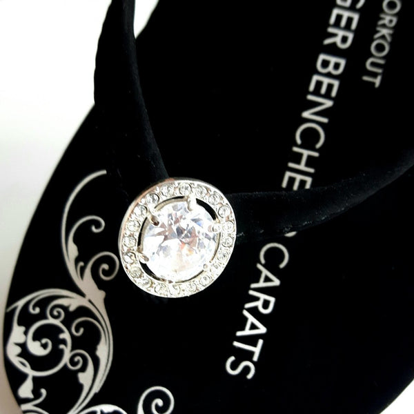 Closeup of vintage diamond ring jewelry on designer flip flops