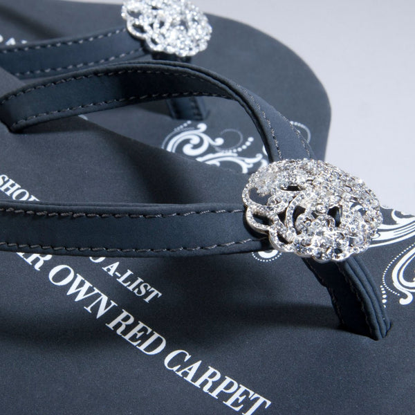 Close up of jewelry Gray Designer Flip Flops Floral Brooch