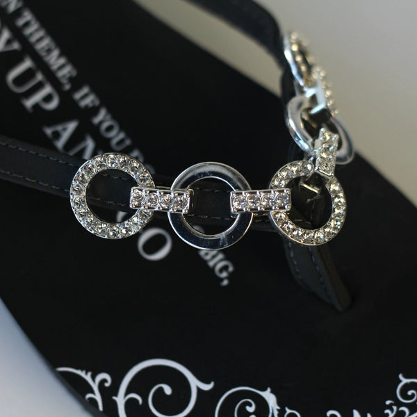 Closeup of Five Link Circle Black Flat Flip Flops Jewelry