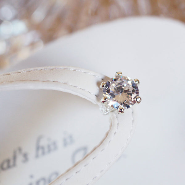Detail of Diamond on white wedding flip flops